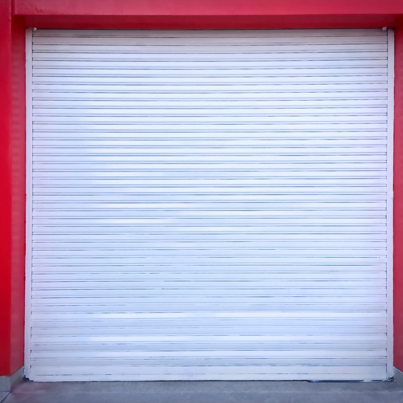 White Roll-up Door on Red Wall of the Garage