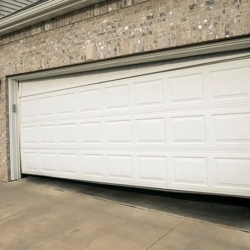 Garage door off track and sitting crooked on a residential home in Ottawa