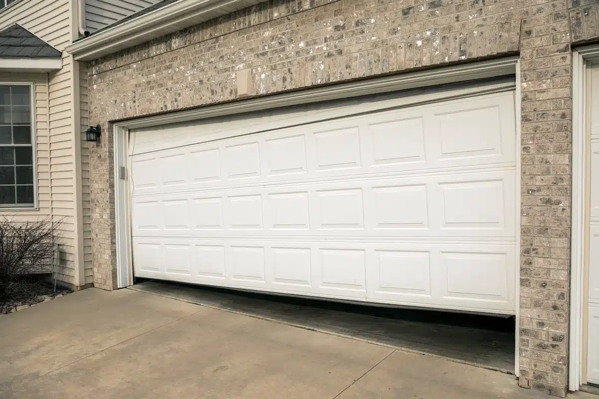 Garage door off track and sitting crooked on a residential home in Ottawa