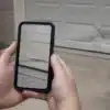 Homeowner documenting garage door damage for insurance claim