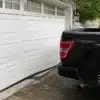Garage door bowed after being backed into by a pickup truck