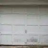 Old garage door with damaged and deteriorated panels