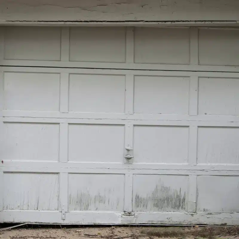 Old garage door with damaged and deteriorated panels