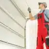 Technician checking a newly installed residential garage door