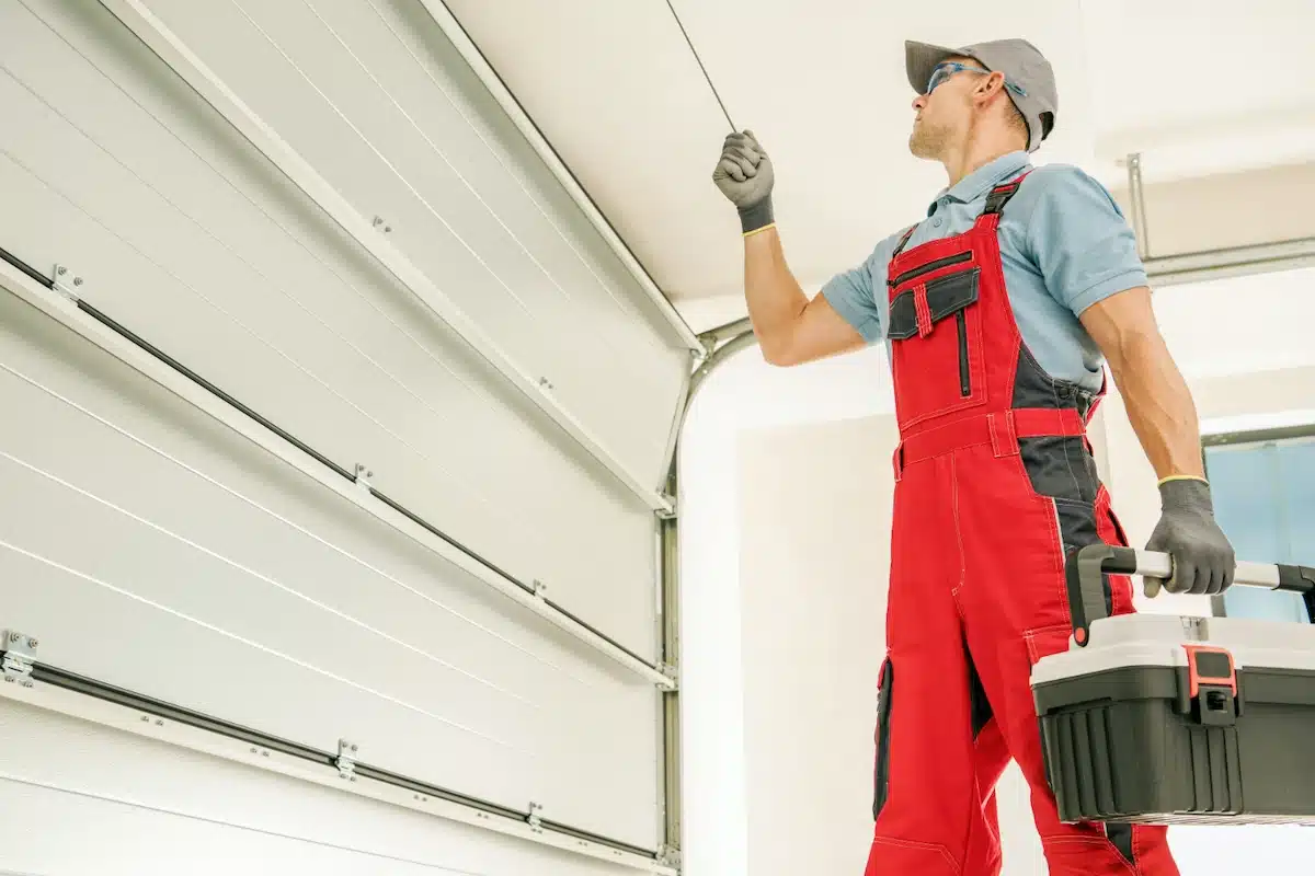 Technician checking a newly installed residential garage door